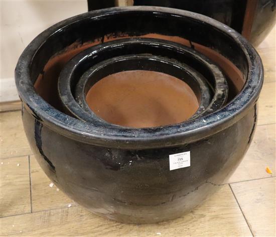 Three black glazed garden pots largest W.52cm